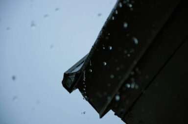 A black umbrella with rain drops on it
