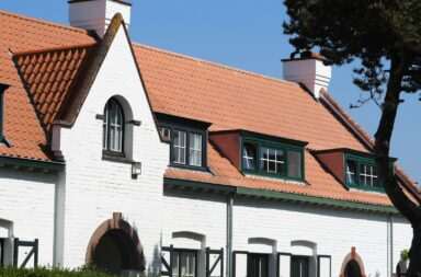 a white house with a red tiled roof